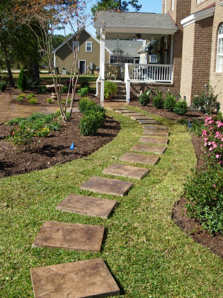 Integrally colored concrete with dark brown accents and seamless stamp texture.